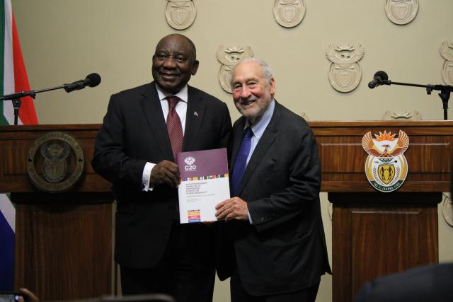 (251104) -- CAPE TOWN, Nov. 4, 2025 (Xinhua) -- South African President Cyril Ramaphosa (L) receives the G20 Extraordinary Committee Report on Global Inequality from Nobel Laureate Joseph Stiglitz  at a ceremony in Cape Town, South Africa, on Nov. 4, 2025. A G20 report commissioned under South Africa's presidency has sounded the alarm over an escalating global inequality crisis, calling for the creation of a new international panel to guide policymaking at both national and global levels. (Photo by Shakirah Thebus/Xinhua)