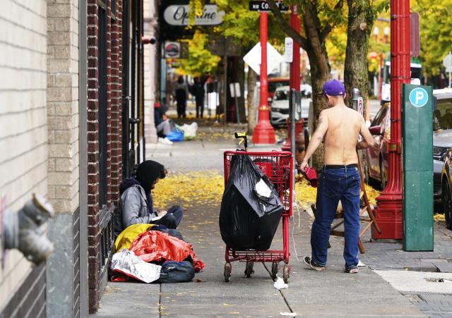 (251104) -- PORTLAND, Nov. 4, 2025 (Xinhua) -- Homeless persons are seen on the sidewalk in Portland, Oregon, the United States, Nov. 4, 2025. The U.S. Senate on Tuesday again failed to pass a temporary funding bill, marking the 14th unsuccessful attempt. This means the federal government shutdown is on track to surpass the 35-day record set during the 2018-2019 shutdown and become the longest in U.S. history. (Xinhua/Wu Xiaoling)