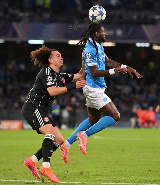 (251105) -- NAPLES, Nov. 5, 2025 (Xinhua) -- Napoli's Andre-Frank Anguissa (R) vies with Frankfurt's Arthur Theate during the UEFA Champions League football match between Napoli and Frankfurt in Naples, Italy, on Nov. 4, 2025. (Photo by Alberto Lingria/Xinhua)