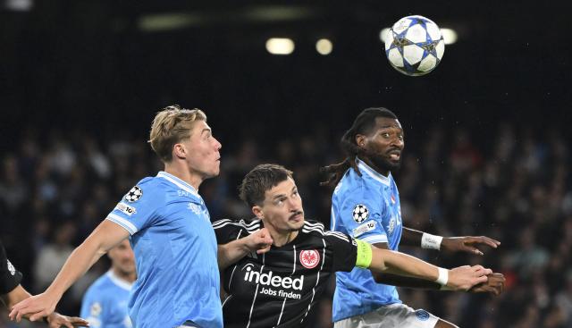 (251105) -- NAPLES, Nov. 5, 2025 (Xinhua) -- Napoli's Rasmus Hojlund (L) and Andre-Frank Anguissa (R) vies with Frankfurt's Robin Koch during the UEFA Champions League football match between Napoli and Frankfurt in Naples, Italy, on Nov. 4, 2025. (Photo by Alberto Lingria/Xinhua)