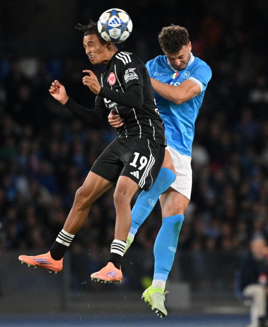 (251105) -- NAPLES, Nov. 5, 2025 (Xinhua) -- Napoli's Amir Rrahmani (R) vies with Frankfurt's Jean-Matteo Bahoya during the UEFA Champions League football match between Napoli and Frankfurt in Naples, Italy, on Nov. 4, 2025. (Photo by Alberto Lingria/Xinhua)