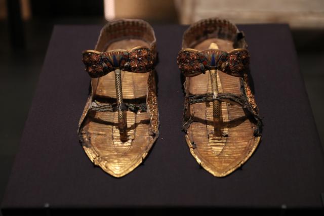 (251105) -- GIZA, Nov. 5, 2025 (Xinhua) -- This photo taken on Nov. 4, 2025 shows a pair of sandals at the King Tutankhamun exhibition hall of the Grand Egyptian Museum in Giza, Egypt.
  The Grand Egyptian Museum (GEM) opened its doors to the public on Tuesday, establishing itself as one of the world's largest displays of ancient relics, and a high-tech fort dedicated to heritage conservation.
  The main galleries display thousands of previously stored antiquities for the first time, housing the complete collection of some 5,992 artifacts from the tomb of the boy-king Tutankhamun. (Xinhua/Sui Xiankai)