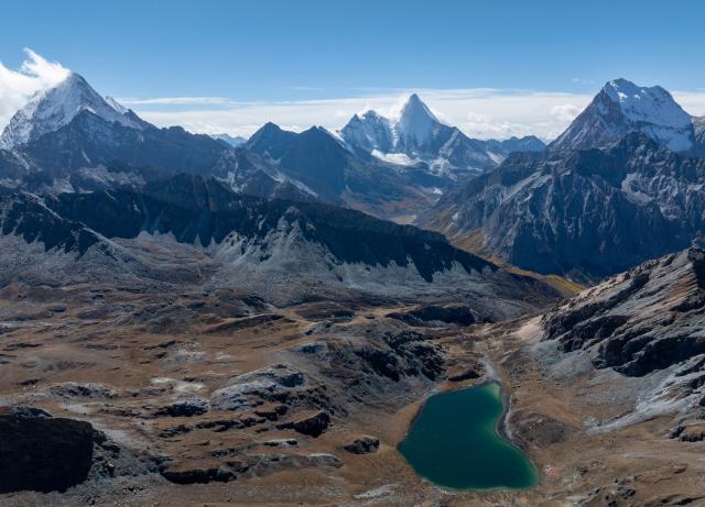 (251106) -- DAOCHENG, Nov. 6, 2025 (Xinhua) -- A drone photo taken on Oct. 28, 2025 shows a view of the Yading scenic spot in Daocheng County of Tibetan Autonomous Prefecture of Garze, southwest China's Sichuan Province. The Yading scenic spot is in its best viewing season recently, attracting flocks of tourists there. (Xinhua/Jiang Hongjing)