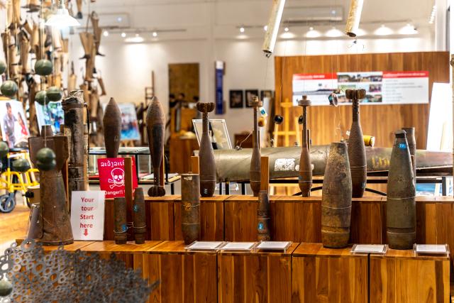 (251106) -- VIENTIANE, Nov. 6, 2025 (Xinhua) -- This photo taken on Nov. 6, 2025 shows the bomb shells displayed in the Cooperative Orthotic and Prosthetic Enterprise (COPE), also known as the COPE Visitor Center, in Vientiane, Laos. The Cooperative Orthotic and Prosthetic Enterprise, located in Vientiane, capital of Laos, displays various prosthetics and war remnants such as bomb shells, documenting the damage caused by wars and unexploded ordnance to Laos. (Photo by Kaikeo Saiyasane/Xinhua)