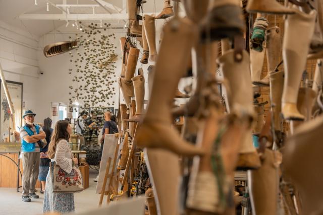 (251106) -- VIENTIANE, Nov. 6, 2025 (Xinhua) -- Tourists visit the Cooperative Orthotic and Prosthetic Enterprise (COPE), also known as the COPE Visitor Center, in Vientiane, Laos, Nov. 6, 2025. The Cooperative Orthotic and Prosthetic Enterprise, located in Vientiane, capital of Laos, displays various prosthetics and war remnants such as bomb shells, documenting the damage caused by wars and unexploded ordnance to Laos. (Photo by Kaikeo Saiyasane/Xinhua)