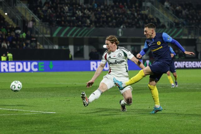 (251107) -- LJUBLJANA, Nov. 7, 2025 (Xinhua) -- Mario Kvesic (R) of NK Celje shoots during the UEFA Conference League match between NK Celje and Legia Warszawa in Celje, Slovenia, on Nov. 6, 2025. (Photo by Zeljko Stevanic/Xinhua)