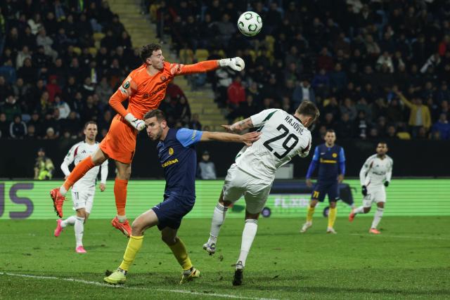 (251107) -- LJUBLJANA, Nov. 7, 2025 (Xinhua) -- Zan Luk Leban (top), goalkeeper of NK Celje, saves the goal during the UEFA Conference League match between NK Celje and Legia Warszawa in Celje, Slovenia, on Nov. 6, 2025. (Photo by Zeljko Stevanic/Xinhua)