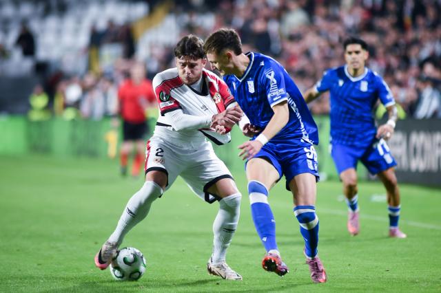 (251107) -- MADRID, Nov. 7, 2025 (Xinhua) -- Andrei Ratiu (front L) of Rayo Vallecano vies with Kornel Lisman (front R) of Lech Poznan during the round 3 match between Rayo Vallecano and Lech Poznan at the 2025-2026 UEFA Europa Conference League in Madrid, Spain, Nov. 6, 2025. (Photo by Gustavo Valiente/Xinhua)