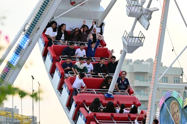 (251107) -- HAWALLI GOVERNORATE, Nov. 7, 2025 (Xinhua) -- Visitors enjoy their time at "Winter Wonderland Kuwait" in Hawalli Governorate, Kuwait, Nov. 6, 2025. "Winter Wonderland Kuwait", one of the largest entertainment projects in the country, opened its fourth season here on Thursday. (Photo by Asad/Xinhua)