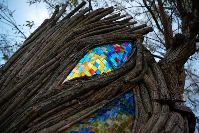 (251107) -- BEIJING, Nov. 7, 2025 (Xinhua) -- This photo taken on Nov. 5, 2025 shows a close-up of the stained glass on the "Willow Temple" in Warsaw, Poland. The "Willow Temple" is an artistic installation made from a hollow, withered willow tree, transformed with stained glass, metal and wooden elements into a chapel-like space that blends nature and art. (Photo by Jaap Arriens/Xinhua)