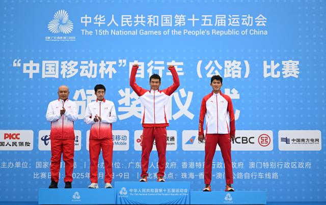 (251107) -- ZHUHAI, Nov. 7, 2025 (Xinhua) -- Gold medalist Miao Chengshuo (2nd R) of Shandong, silver medalist Xue Ming (2nd L) of Tianjin, bronze medalist Cao Houwang (1st R) of Shandong react during the awarding ceremony for the men's individual time trial of cycling road at China's 15th National Games in Zhuhai, south China's Guangdong Province, Nov. 7, 2025. (Xinhua/Deng Hua)