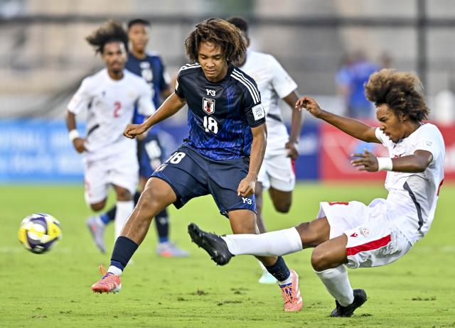 (251107) -- DOHA, Nov. 7, 2025 (Xinhua) -- McGhee Jelani Ren (front L) of Japan vies with Steevy Andrew (front R) of New Caledonia during the FIFA U-17 World cup Qatar 2025 group B match between Japan and New Caledonia in Doha, Qatar, on Nov. 6, 2025. (Photo by Nikku/Xinhua)