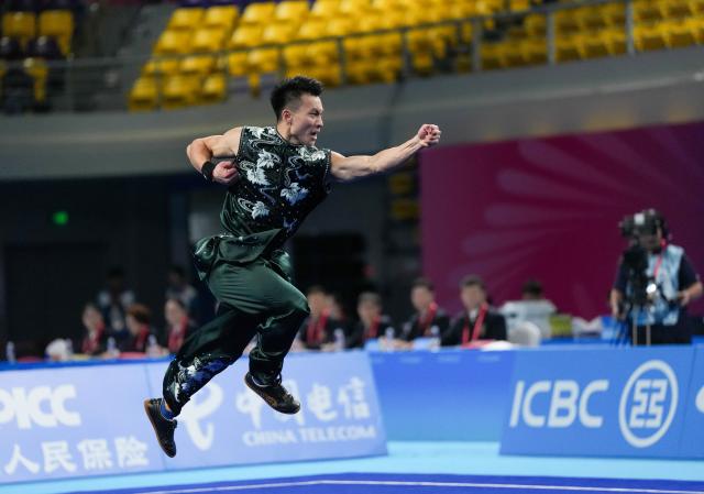 (251107) -- GUANGZHOU, Nov. 7, 2025 (Xinhua) -- Cheng Kaijie of Shandong competes during the men's Nanquan-Nandao-Nangun of Wushu Taolu event at China's 15th National Games in Guangzhou, south China's Guangdong Province, Nov. 7, 2025. (Xinhua/Jigme Dorji)