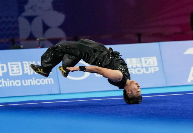 (251107) -- GUANGZHOU, Nov. 7, 2025 (Xinhua) -- Huang Zongtao of Beijing Sport University competes during the men's Nanquan-Nandao-Nangun of Wushu Taolu event at China's 15th National Games in Guangzhou, south China's Guangdong Province, Nov. 7, 2025. (Xinhua/Jigme Dorji)