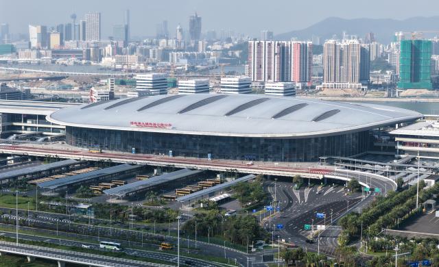 (251107) -- GUANGZHOU, Nov. 7, 2025 (Xinhua) -- An aerial drone photo taken on Oct. 19, 2025 shows the Zhuhai Port of the Hong Kong-Zhuhai-Macao Bridge in Zhuhai, south China's Guangdong Province, with the urban view of Macao Special Administrative Region (SAR) in the background. (Xinhua/Deng Hua)