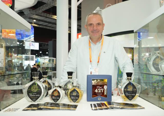 (251107) -- SHANGHAI, Nov. 7, 2025 (Xinhua) -- This photo shows bottles of liquor from Serbia at the Food and Agricultural Products exhibition area during the eighth China International Import Expo in east China's Shanghai, Nov. 6, 2025. The eighth CIIE opened here on Wednesday. Enterprises from a total of 123 Belt and Road partner countries participated in this year's CIIE, increasing by 23.1 percent year on year. (Xinhua/Ren Pengfei)