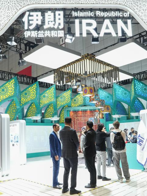 (251107) -- SHANGHAI, Nov. 7, 2025 (Xinhua) -- People communicate with each other at the pavilion of Iran during the eighth China International Import Expo (CIIE) in east China's Shanghai, Nov. 7, 2025. The eighth CIIE opened here on Wednesday. Enterprises from a total of 123 Belt and Road partner countries participated in this year's CIIE, increasing by 23.1 percent year on year. (Xinhua/Ren Pengfei)