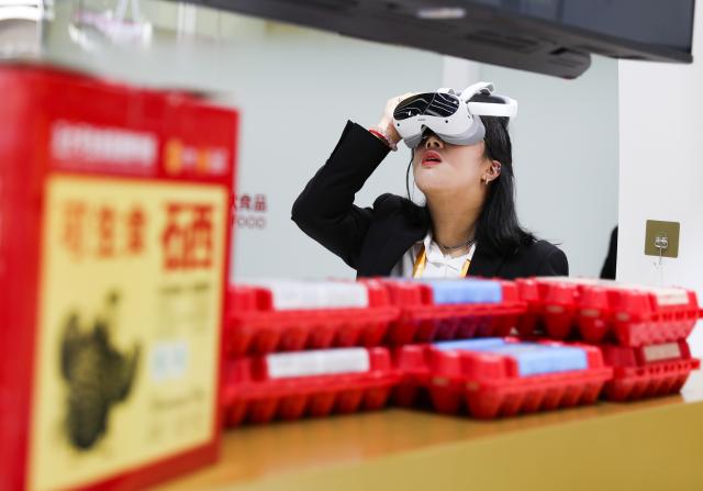 (251107) -- SHANGHAI, Nov. 7, 2025 (Xinhua) -- A woman tries a VR device at the booth of CP Group, an eight-year attendee of the China International Import Expo (CIIE), during the eighth CIIE in east China's Shanghai, Nov. 7, 2025. The eighth CIIE, which opened in Shanghai on Wednesday and will last till Nov. 10, has attracted 4,108 overseas exhibitors from 155 countries, regions and international organizations.
  Among the participants, 170 enterprises and 27 institutions have maintained full attendance at the CIIE for eight consecutive years, reflecting China's firm commitment to high-level opening-up. (Xinhua/Wang Jingqiang)