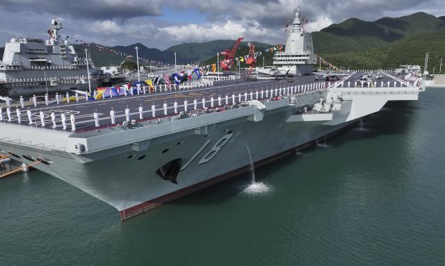 (251107) -- SANYA, Nov. 7, 2025 (Xinhua) -- The commissioning and flag-presenting ceremony of the Fujian, China's first aircraft carrier equipped with electromagnetic catapults, is held at a naval port in Sanya City, south China's Hainan Province, on Nov. 5, 2025. The Fujian was launched in June 2022 and named after Fujian Province. (Xinhua/Li Gang)