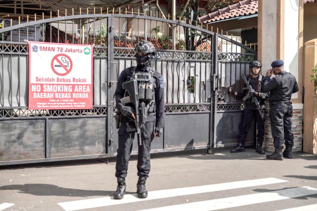 (251107) -- JAKARTA, Nov. 7, 2025 (Xinhua) -- Police officers stand guard in front of a school after an explosion hit the school mosque in Jakarta, Indonesia, Nov. 7, 2025. An explosion at a mosque inside a school in Jakarta, the capital of Indonesia, during Friday prayers injured 54 people, the city's police chief Asep Edi Suheri said. (Photo by B.Nugraha/Xinhua)