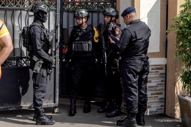 (251107) -- JAKARTA, Nov. 7, 2025 (Xinhua) -- Police officers stand guard in front of a school after an explosion hit the school mosque in Jakarta, Indonesia, Nov. 7, 2025. An explosion at a mosque inside a school in Jakarta, the capital of Indonesia, during Friday prayers injured 54 people, the city's police chief Asep Edi Suheri said. (Photo by B.Nugraha/Xinhua)
