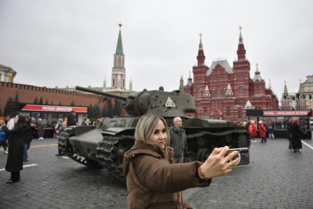 (251107) -- MOSCOW, Nov. 7, 2025 (Xinhua) -- A woman poses for photos at an outdoor exhibition commemorating the military parade in 1941 at Red Square in Moscow, Russia, Nov. 7, 2025. (Photo by Alexander Zemlianichenko Jr/Xinhua)