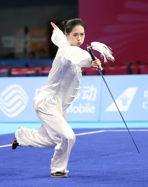 (251107) -- GUANGZHOU, Nov. 7, 2025 (Xinhua) -- Tong Xin of Fujian competes during the women's Taijijian competition of Taijiquan-Taijijian of Wushu Taolu event at China's 15th National Games in Guangzhou, south China's Guangdong Province, Nov. 7, 2025. (Xinhua/Yang Shiyao)