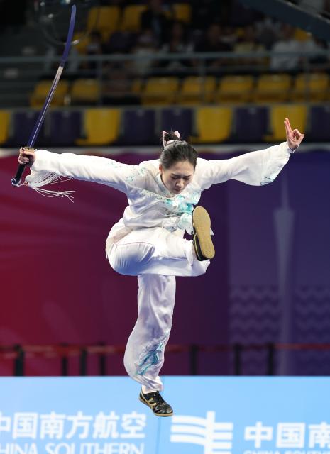 (251107) -- GUANGZHOU, Nov. 7, 2025 (Xinhua) -- Tong Xin of Fujian competes during the women's Taijijian competition of Taijiquan-Taijijian of Wushu Taolu event at China's 15th National Games in Guangzhou, south China's Guangdong Province, Nov. 7, 2025. (Xinhua/Yang Shiyao)