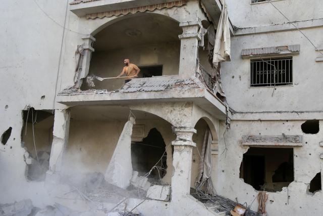 (251107) -- TAYR DEBBA(LEBANON), Nov. 7, 2025 (Xinhua) -- A man cleans the rubble of a building destroyed by Israeli air raids a day earlier in the southern town of Tayr Debba, Lebanon on Nov. 7, 2025. (Photo by Ali Hashisho/Xinhua)