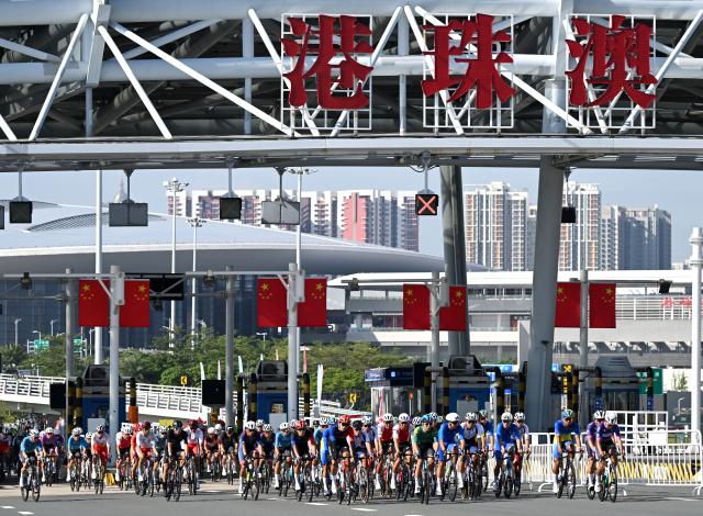 (251108) -- ZHUHAI, Nov. 8, 2025 (Xinhua) -- Cyclists compete across the Hong Kong-Zhuhai-Macao Bridge during the men's road race of cycling road at China's 15th National Games in south China's Guangdong Province, Nov. 8, 2025. (Xinhua/Lian Zhen)