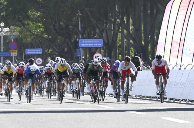 (251108) -- ZHUHAI, Nov. 8, 2025 (Xinhua) -- Cyclists cross the finish line during the men's road race of cycling road at China's 15th National Games in south China's Guangdong Province, Nov. 8, 2025. (Xinhua/Lian Zhen)