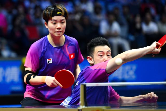 (251108) -- MACAO, Nov. 8, 2025 (Xinhua) -- Wong Chun Ting (front)/Doo Hoi Kem compete during the table tennis mixed doubles round of 16 match between Wong Chun Ting/Doo Hoi Kem of Hong Kong and Zhou Yu/Zang Xiaotong of Hebei at China's 15th National Games in Macao, south China, Nov. 8, 2025. (Xinhua/Cheong Kam Ka)