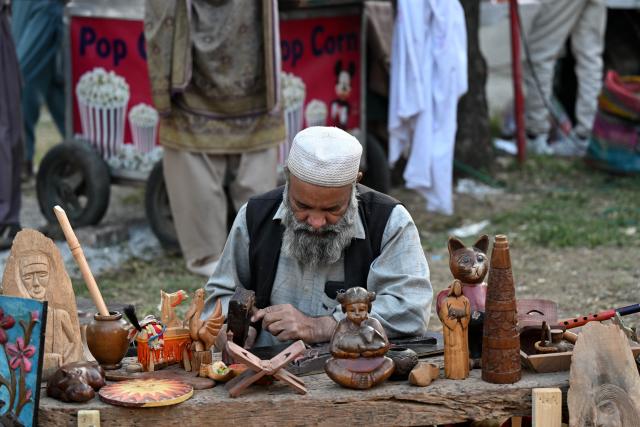 (251108) -- ISLAMABAD, Nov. 8, 2025 (Xinhua) -- An artist processes wooden handicrafts during the Lok Mela Festival in Islamabad, capital of Pakistan, Nov. 7, 2025. The annual ten-day folk festival kicked off here on Friday. (Photo by Ahmad Kamal/Xinhua)