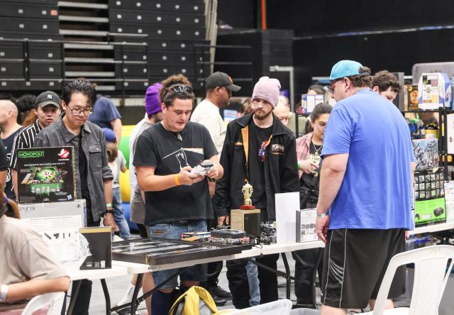 (251108) -- AUCKLAND, Nov. 8, 2025 (Xinhua) -- People attend a retro-themed fair in Auckland, New Zealand, Nov. 8, 2025. The fair showcased items related to vintage films, games, and animation, attracting people to visit and shop. (Xinhua/Long Lei)