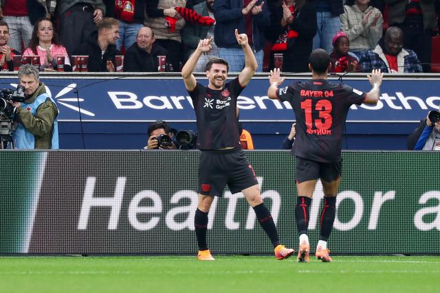 (251109) -- LEVERKUSEN, Nov. 9, 2025 (Xinhua) -- Jonas Hofmann (C) of Bayer 04 Leverkusen celebrates scoring with his teammate Arthur (R) during the German first division of Bundesliga football match between Bayer 04 Leverkusen and 1. FC Heidenheim 1846 in Leverkusen, Germany, Nov. 8. 2025. (Photo by Joachim Bywaletz/Xinhua)