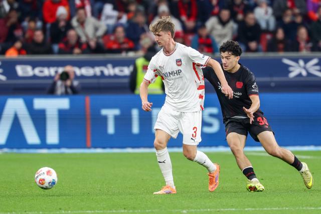 (251109) -- LEVERKUSEN, Nov. 9, 2025 (Xinhua) -- Ibrahim Maza (R) of Bayer 04 Leverkusen vies with Jan Schoeppner of 1. FC Heidenheim 1846 during the German first division of Bundesliga football match between Bayer 04 Leverkusen and 1. FC Heidenheim 1846 in Leverkusen, Germany, Nov. 8. 2025. (Photo by Joachim Bywaletz/Xinhua)