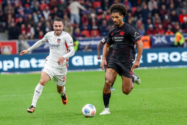 (251109) -- LEVERKUSEN, Nov. 9, 2025 (Xinhua) -- Loic Bade (R) of Bayer 04 Leverkusen vies with Arijon Ibrahimovic of 1. FC Heidenheim 1846 during the German first division of Bundesliga football match between Bayer 04 Leverkusen and 1. FC Heidenheim 1846 in Leverkusen, Germany, Nov. 8. 2025. (Photo by Joachim Bywaletz/Xinhua)