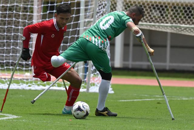 (251109) -- JAKARTA, Nov. 9, 2025 (Xinhua) -- Agung Rizki Satria  (L) of Indonesia vies with Mustafa Nattouf of Syria during Group A match between Indonesia and Syria at the Asian Amputee Football Cup Qualifiers 2025 in Jakarta, Indonesia, Nov. 9, 2025. (Xinhua/Agung Kuncahya B.)