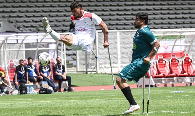 (251109) -- JAKARTA, Nov. 9, 2025 (Xinhua) -- Mohammad Alitabar Firouzjah (L) of Iran competes during the Group A match between Iran and Iraq at the Asian Amputee Football Cup Qualifiers 2025 in Jakarta, Indonesia, Nov. 9, 2025. (Xinhua/Agung Kuncahya B.)