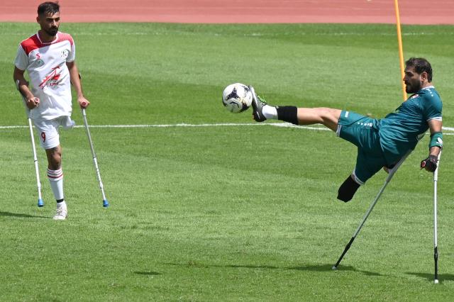 (251109) -- JAKARTA, Nov. 9, 2025 (Xinhua) -- Omar Najm Abbood (R) of Iraq kicks the ball during the Group A match between Iran and Iraq at the Asian Amputee Football Cup Qualifiers 2025 in Jakarta, Indonesia, Nov. 9, 2025. (Xinhua/Agung Kuncahya B.)