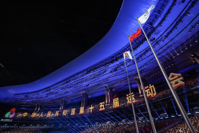 (251109) -- GUANGZHOU, Nov. 9, 2025 (Xinhua) -- Flags are raised during the opening ceremony of China's 15th National Games in Guangzhou, south China's Guangdong Province, Nov. 9, 2025. (Xinhua/Pan Yulong)