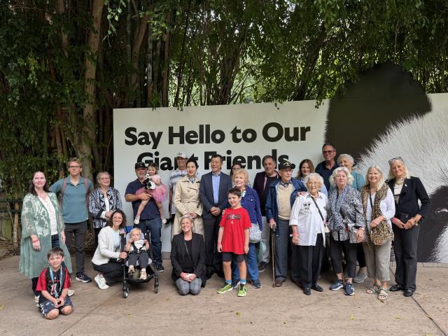 (251110) -- SAN DIEGO, Nov. 10, 2025 (Xinhua) -- Chinese Consul General in Los Angeles Guo Shaochun poses for a group photo with a veteran and other family members of the Flying Tigers during a special meet and greet with the giant pandas Yun Chuan and Xin Bao at the San Diego Zoo in San Diego, California, the United States, Nov. 8, 2025. TO GO WITH "Feature: Flying Tigers veteran, family members meet giant pandas in U.S." (Xinhua/Tan Jingjing)