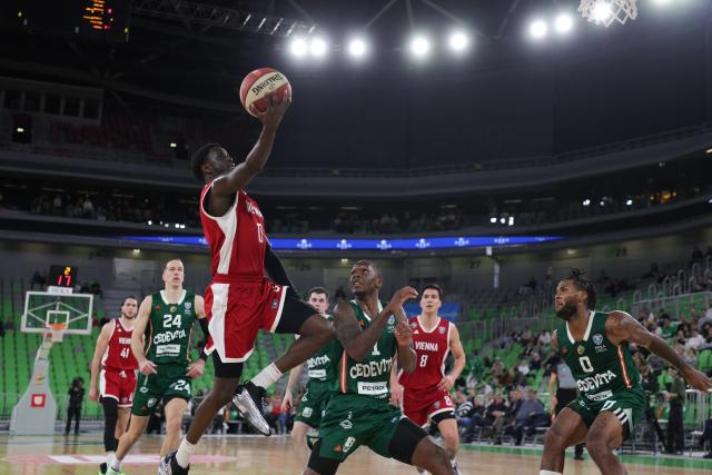 (251110) -- LJUBLJANA, Nov. 10, 2025 (Xinhua) -- Souleymane Boum JR (top) of Vienna goes for a layup during the AdmiralBet ABA League 2025/2026 Round 6 between Cedevita Olimpija and Vienna in Ljubljana, Slovenia, Nov. 9, 2025. (Photo by Zeljko Stevanic/Xinhua)