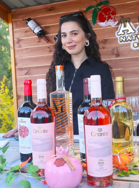 (251110) -- GOYCHAY, Nov. 10, 2025 (Xinhua) -- A woman is pictured at a pomegranate wine stall during the Nar Bayrami pomegranate festival in Goychay, Azerbaijan, Nov. 9, 2025. Azerbaijan's annual Nar Bayrami pomegranate festival was held here on Sunday. The festival was inscribed on the UNESCO Representative List of the Intangible Cultural Heritage of Humanity in 2020. (Xinhua/Chen Junfeng)