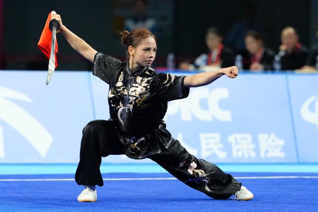 (251110) -- GUANGZHOU, Nov. 10, 2025 (Xinhua) -- He Zhiyi of Guangdong competes during the women's Daoshu competition of Wushu Taolu team event at China's 15th National Games in Guangzhou, south China's Guangdong Province, Nov. 10, 2025. (Xinhua/Zheng Huansong)