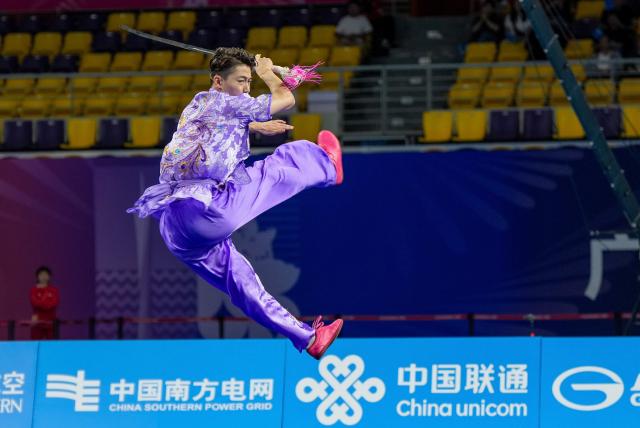 (251110) -- GUANGZHOU, Nov. 10, 2025 (Xinhua) -- Xu Ao of Shandong competes during the men's Jianshu competition of Wushu Taolu team event at China's 15th National Games in Guangzhou, south China's Guangdong Province, Nov. 10, 2025. (Xinhua/Jigme Dorji)