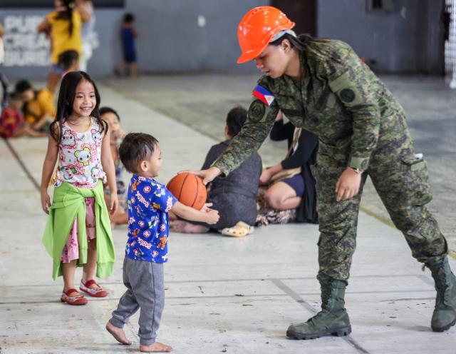 (251110) -- MANILA, Nov. 10, 2025 (Xinhua) -- Children play with a soldier from the Armed Forces of the Philippines inside an evacuation center as they take shelter from Super Typhoon Fung-wong in Manila, the Philippines, Nov. 10, 2025. Super Typhoon Fung-wong made landfall over Aurora province in the eastern part of Luzon Island of the Philippines on Sunday night, according to the state weather bureau.
   Fung-wong is the 21st tropical cyclone hitting the Philippines this year, surpassing the country's annual average of 20 storms. (Xinhua/Rouelle Umali)