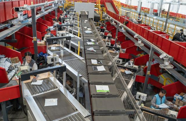 (251110) -- BEIJING, Nov. 10, 2025 (Xinhua) -- Staff members work at an automated parcel sorting line of an express company in Nantong, east China's Jiangsu Province, Nov. 10, 2025. E-commerce and logistics companies across China are busy selling, packaging and delivering goods in the run-up to the annual "Double Eleven" shopping festival which falls on Nov. 11. (Photo by Zhai Huiyong/Xinhua)