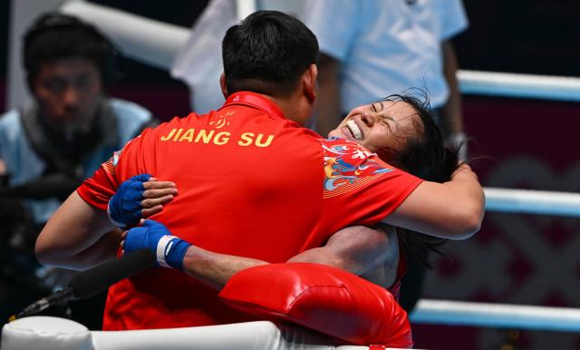 (251110) -- SHENZHEN, Nov. 10, 2025 (Xinhua) -- Xu Zichun (R) of Jiangsu celebrates after defeating Cai Yan of Hebei in the women's -57kg final of boxing at China's 15th National Games in Shenzhen, south China's Guangdong Province, Nov. 10, 2025. (Xinhua/Yang Guanyu)