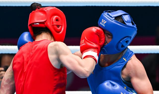 (251110) -- SHENZHEN, Nov. 10, 2025 (Xinhua) -- Xu Zichun (L) of Jiangsu competes against Cai Yan of Hebei during the women's -57kg final of boxing at China's 15th National Games in Shenzhen, south China's Guangdong Province, Nov. 10, 2025. (Xinhua/Yang Guanyu)